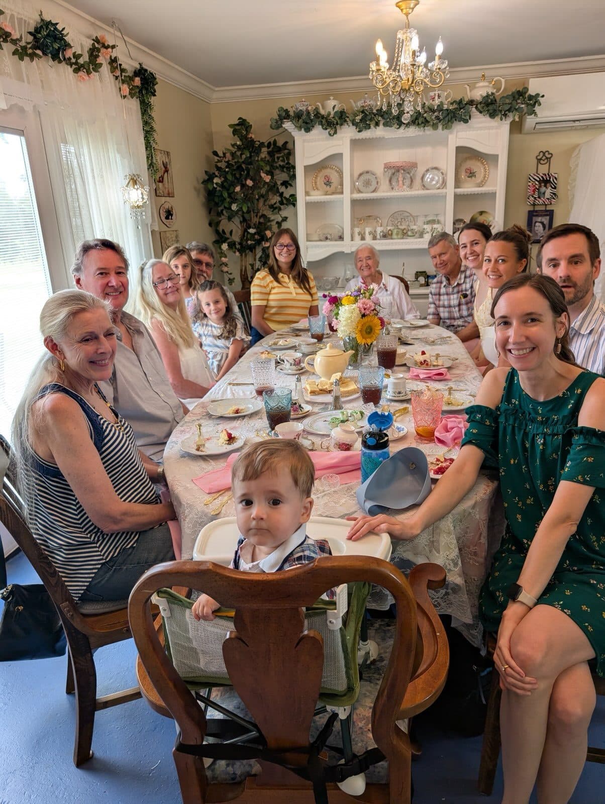 Guests seated around the long table for afternoon tea